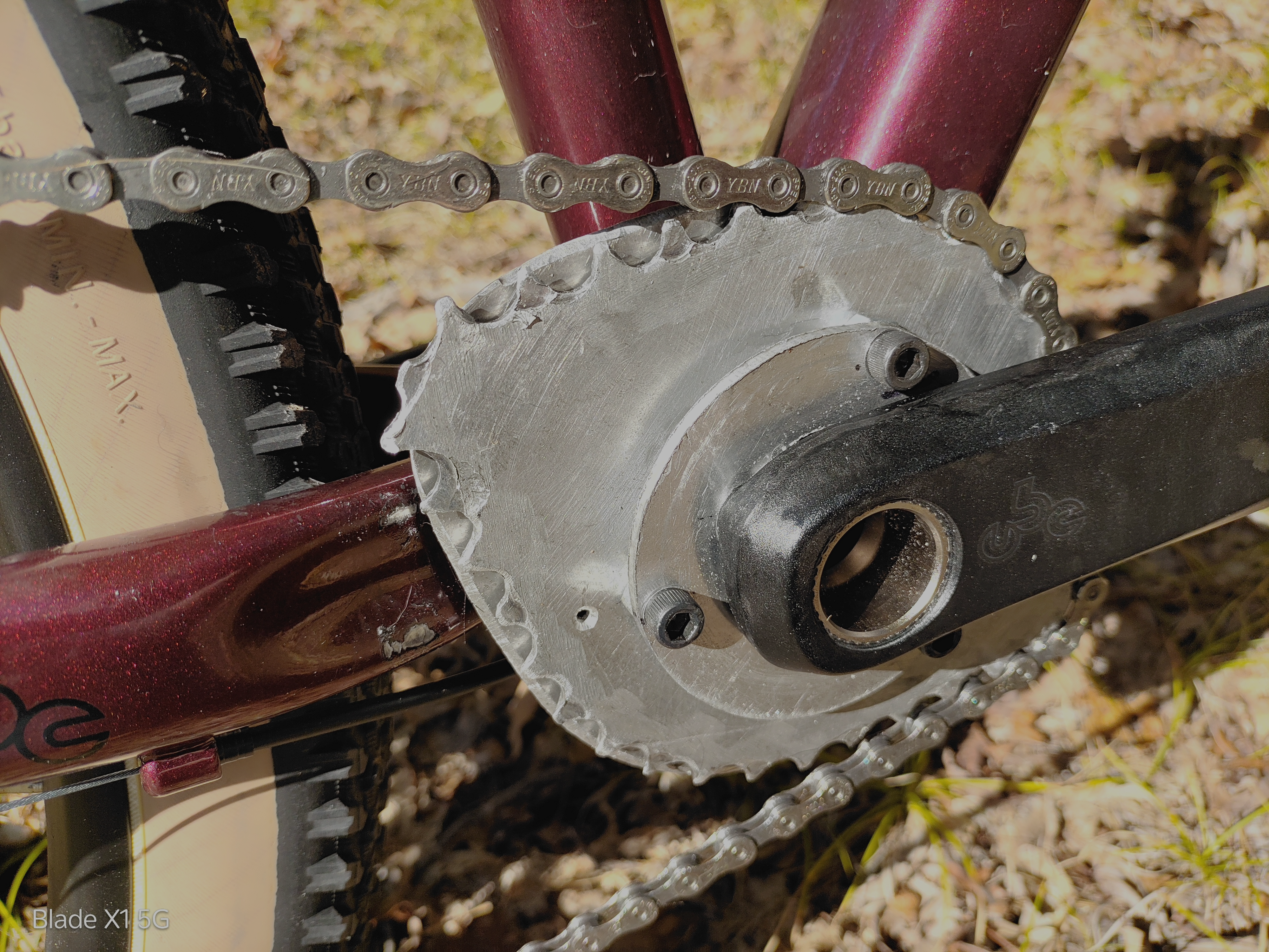 Closeup of the red bike crank showing the backing plate behind the Crownring.